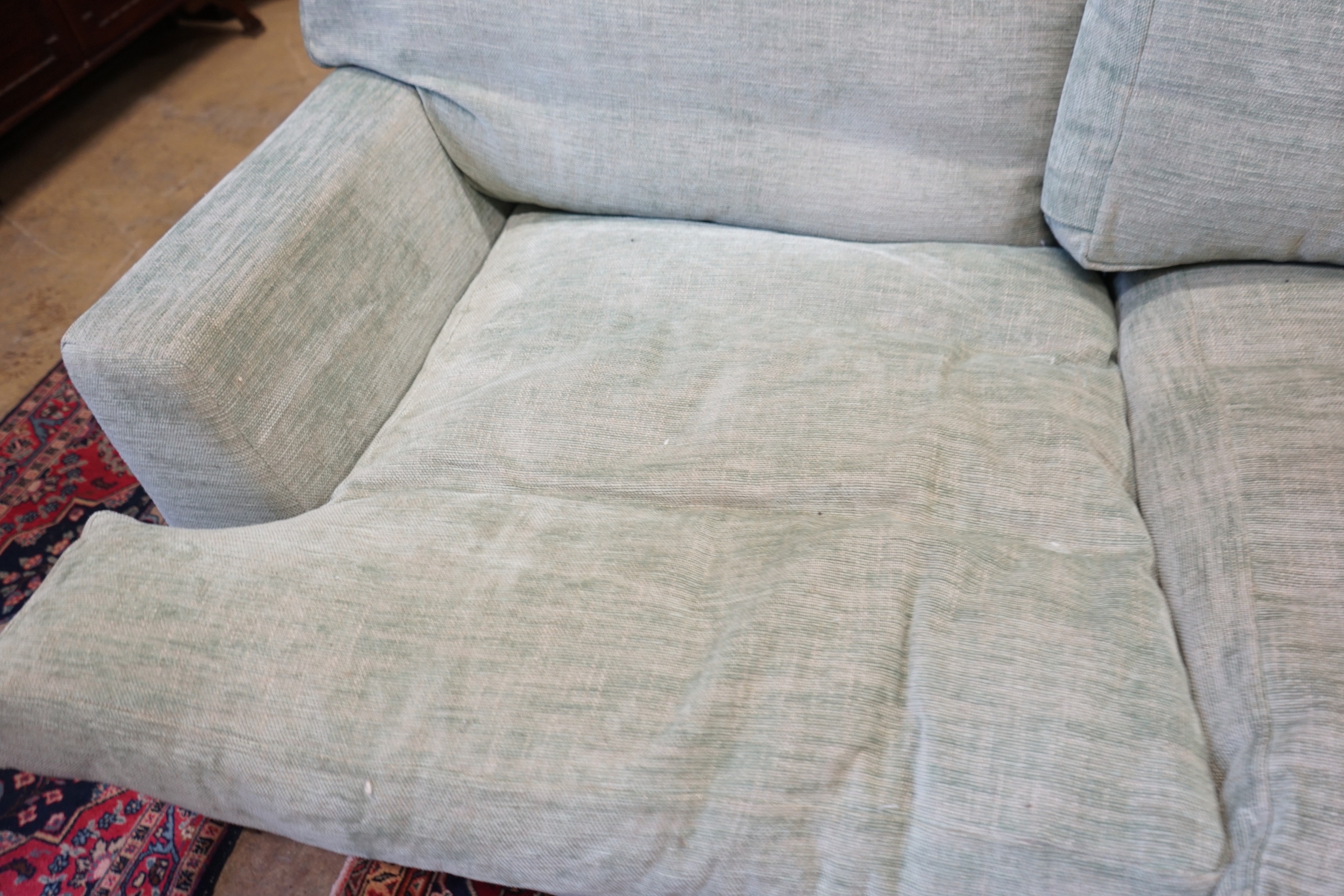 A large Howard style three seater settee upholstered in pale green fabric, length 300cm, depth 120cm, height 92cm